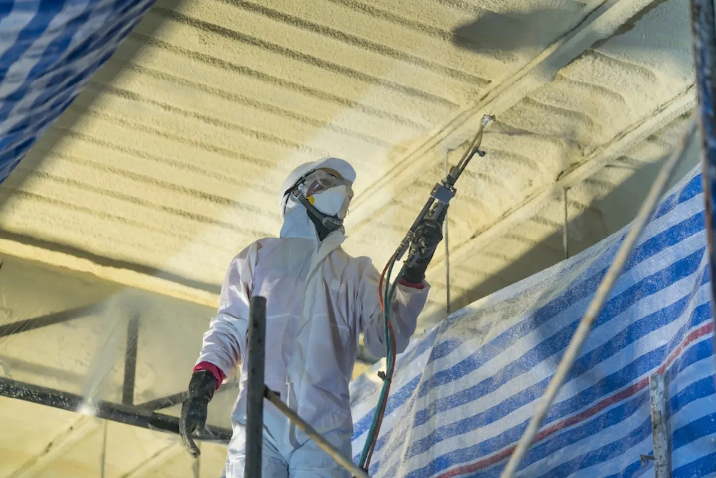 Residential spray foam insulation in a roof and wall assembly